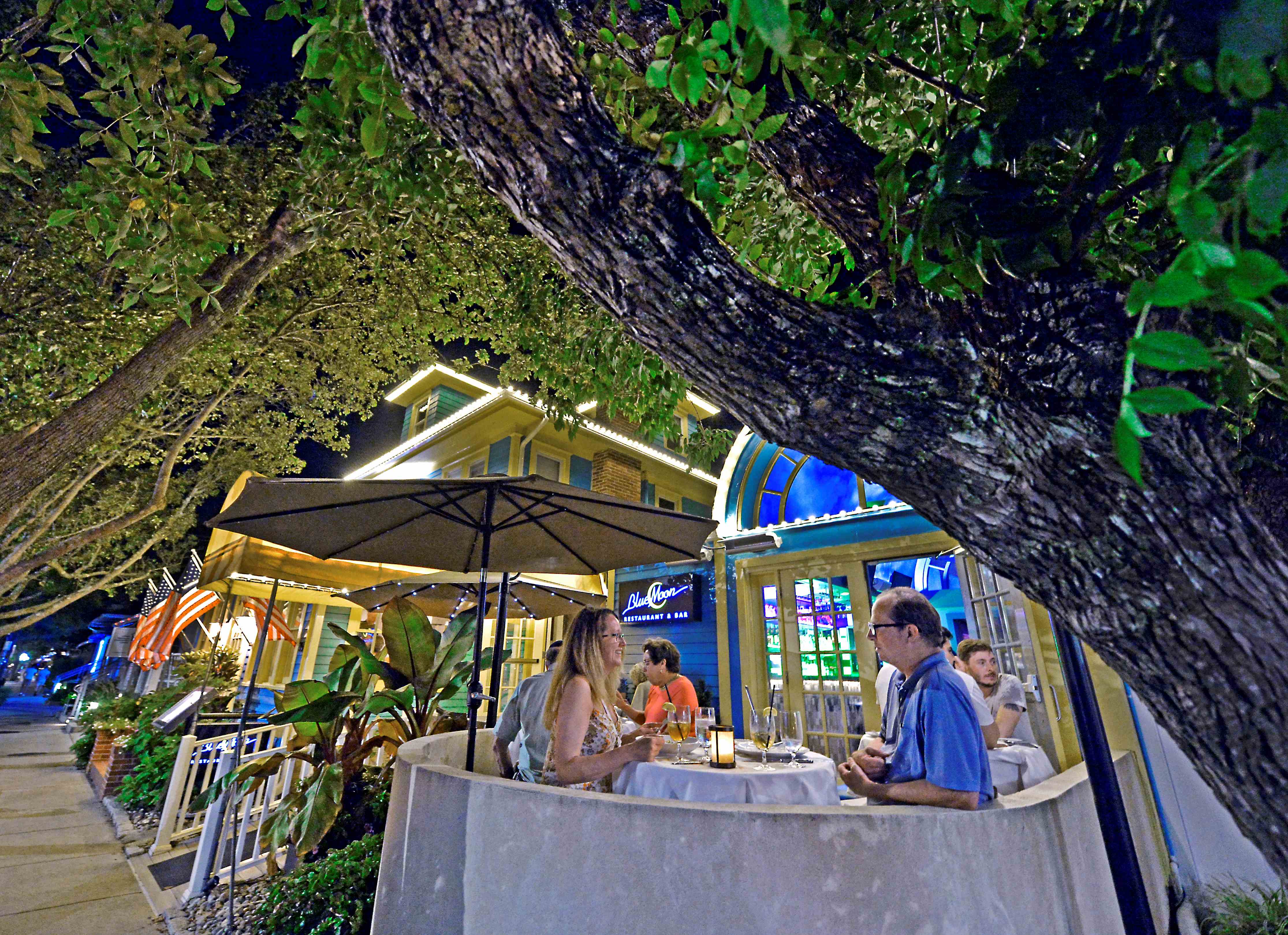 A couple dining outdoors at Blue Moon restaurant
